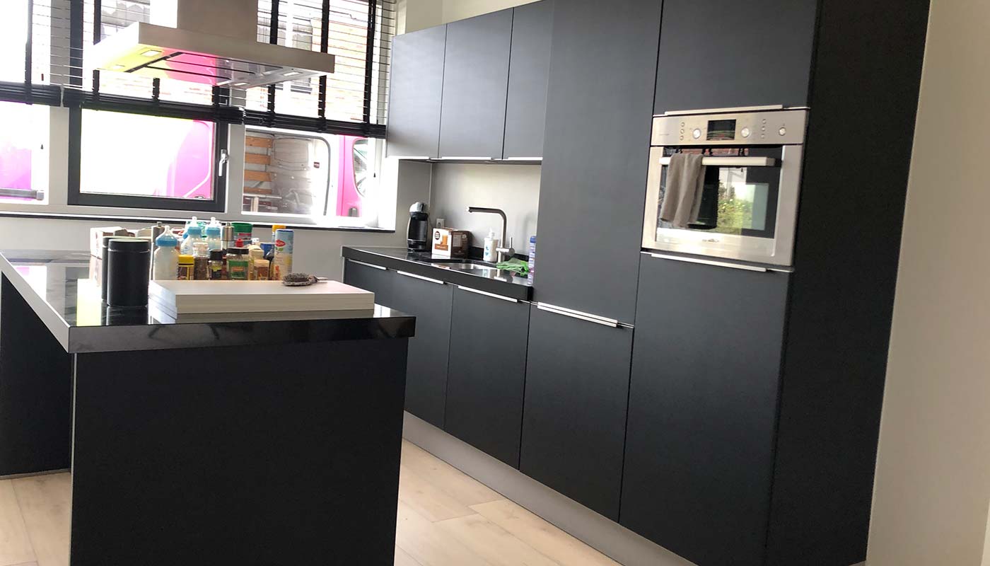 Keuken met matzwarte kasten, professioneel gewrapped voor een moderne en minimalistische look